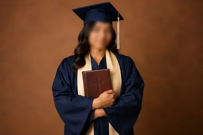 Graduate Holding Bible with Cross Portrait