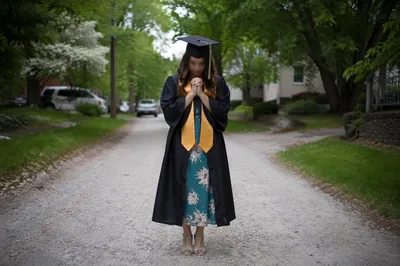 Graduate Praying After Graduation Sunday Service