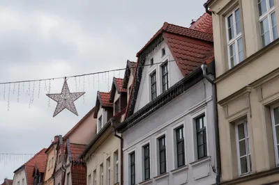 Christmas Lights Hanging Across Townhouse Rooftops