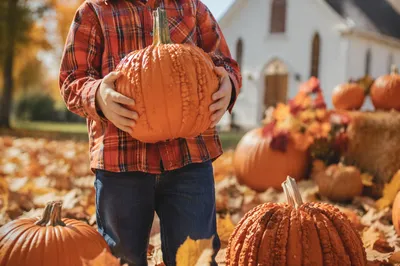 Child Holding Pumpkin at Autumn Church Festival