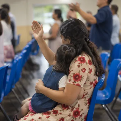 Mother Praying With Child in Spring Gathering