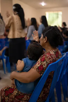 Mother Praying With Child in Spring Gathering