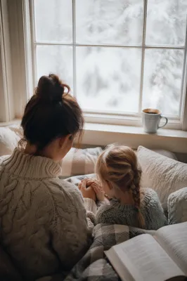 Mother and Child Praying by Winter Window