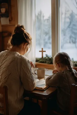 Mother and Child Praying in Winter Light