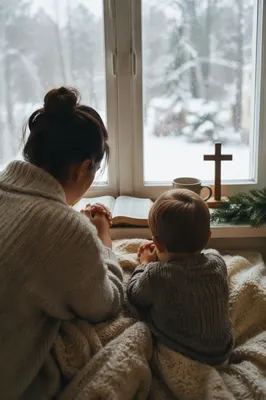 Mother and Child Praying by Winter Window