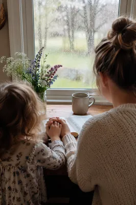 Mother and Child Praying by Spring Window