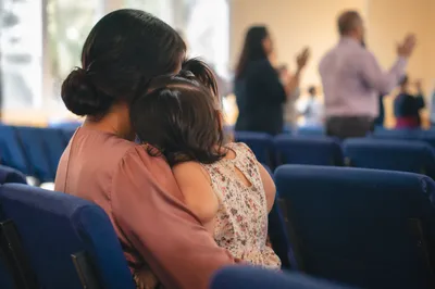Mother and Child Praying in Soft Light