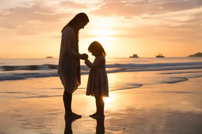 Mother and Child Praying at Golden Shore