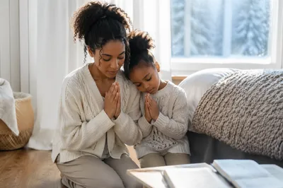 Mother and Daughter Praying by Window