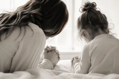Mother and Child Praying in Winter Light