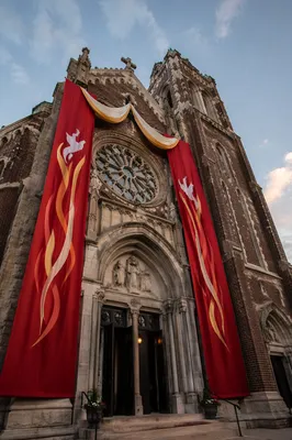 Historic Church Facade with Pentecost Banners