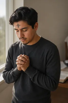 Young Man Praying by Sunlit Window