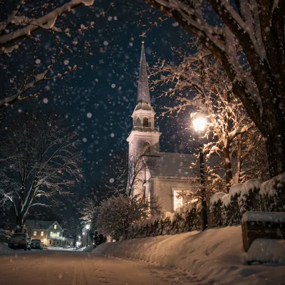 Snow Falling on Church Steeple at Night