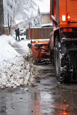 Snowplow Clearing Driveway on Winter Morning