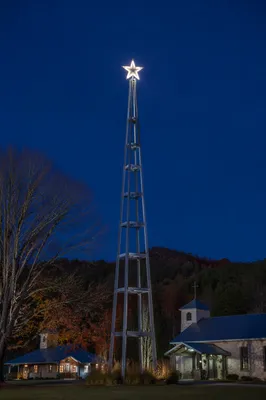 Glowing Bethlehem Star Over Rural Chapel Courtyard