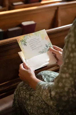 Person Holding Pledge Card and Envelope