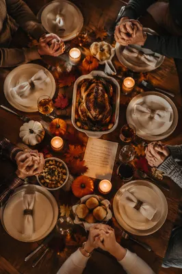 Thanksgiving Family Prayer Around Rustic Dinner Table