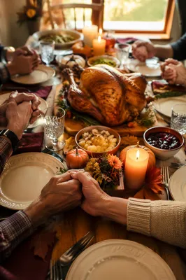 Thanksgiving Family Prayer at Warm Dinner Table