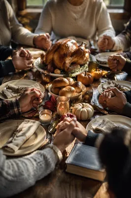 Thanksgiving Family Prayer Around Rustic Dinner Table
