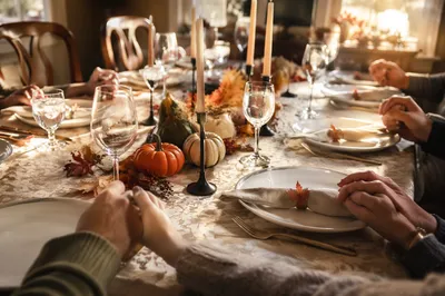 Thanksgiving Family Prayer Around Autumn Dinner Table