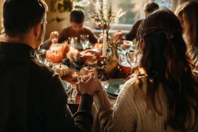 Thanksgiving Family Prayer Around Autumn Dinner Table