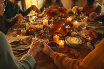 Thanksgiving Family Prayer Around Rustic Dinner Table