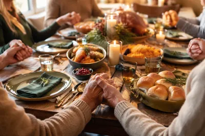 Thanksgiving Family Prayer at Rustic Dinner Table