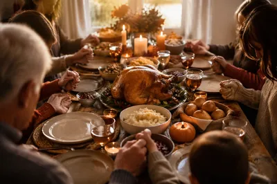 Thanksgiving Family Prayer Around Autumn Dinner Table