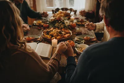 Thanksgiving Family Prayer at Rustic Table