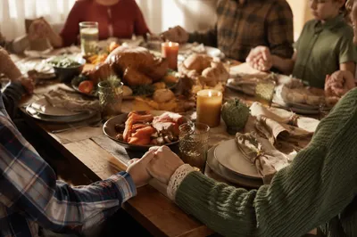 Thanksgiving Family Prayer Around Rustic Dinner Table