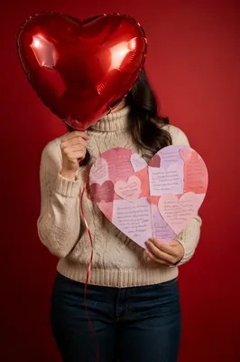 Person Holding Heart Balloon and Card