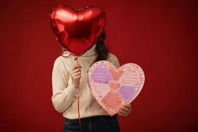 Person Holding Heart Balloon and Card