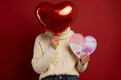 Person Holding Heart Balloon and Card