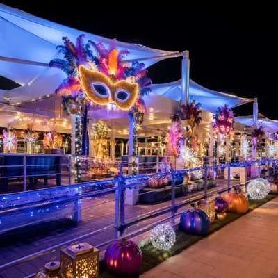 Festive Carnival Masks Under Glowing Canopies