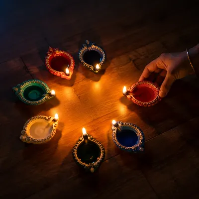 Colorful Diwali Diyas on Wooden Floor