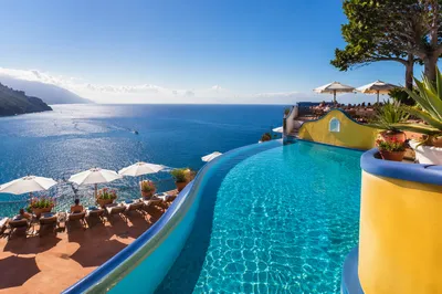 Sunny Resort Pool Overlooking Blue Ocean