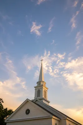 White Church Steeple at Sunrise Sky