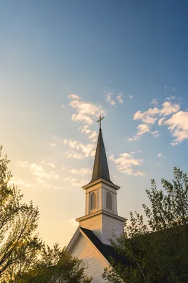 White Church Steeple at Sunrise Sky
