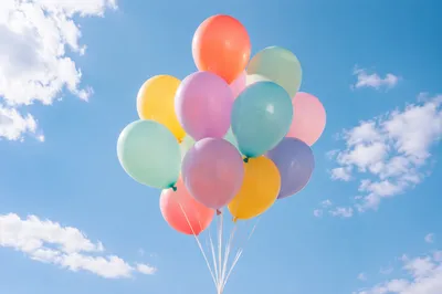 Colorful Balloons Floating in Blue Sky