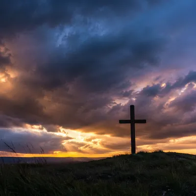 Silhouette Cross on Dramatic Twilight Hill
