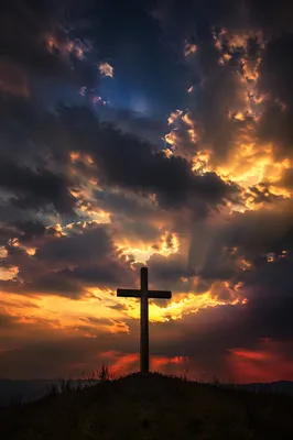 Silhouetted Wooden Cross Under Dramatic Twilight Sky