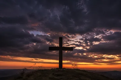 Silhouette Cross Beneath Dramatic Twilight Sky