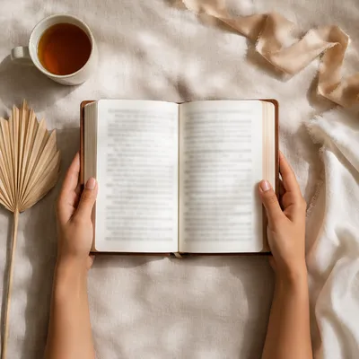 Hands Holding Open Bible Flat Lay