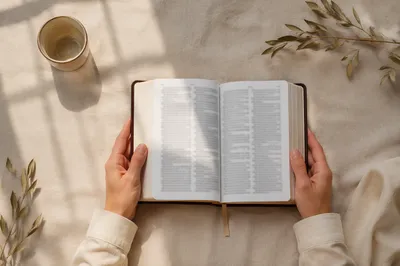 Hands Holding Open Bible Flat Lay