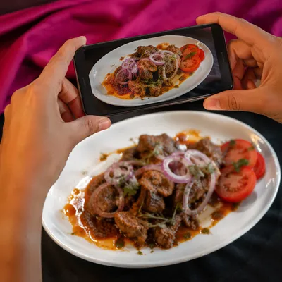 Hands Photographing Gourmet Meal for Social Media