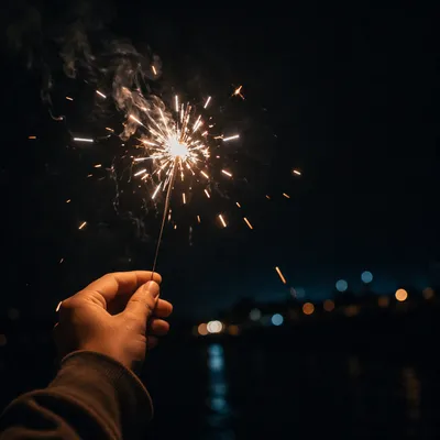 Sparkler Hand Celebration with Dark Copy Space