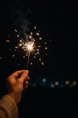 Sparkler Hand Celebration with Dark Copy Space