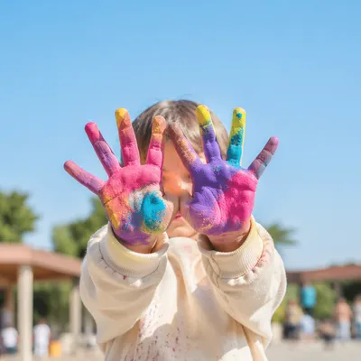 Child Hiding Face with Painted Hands
