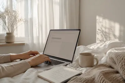 Cozy Laptop Workspace on White Bed