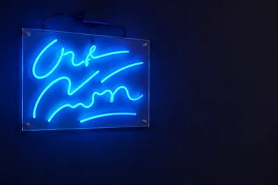 Cyan Neon Motivation Sign on Indigo Wall